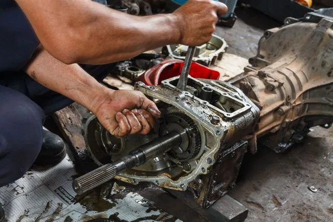 A technician working on an opened transmission