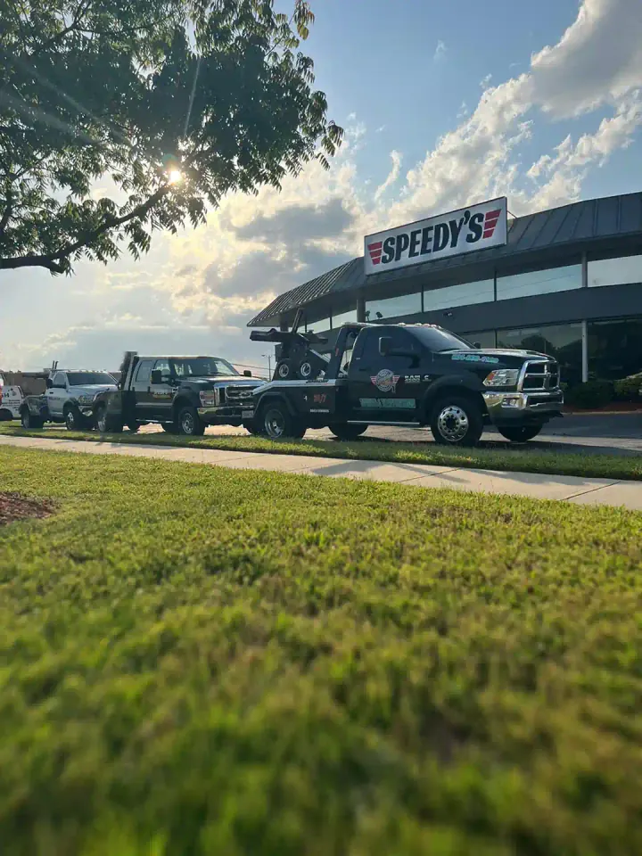 Speedy's tow truck outside the shop